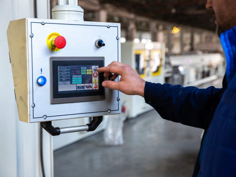 worker uses control panel in factory